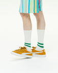 A person wearing a pair of tennis shoes.