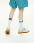 A man in blue shorts and white socks.