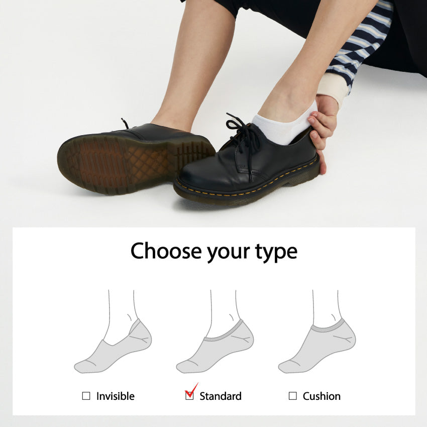 A woman is tying her shoes with a pair of socks.