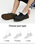 A woman is tying her shoes with a pair of socks.