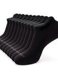 A dozen of black socks sitting on top of each other.