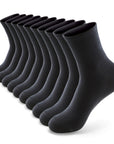 A dozen of black socks on a white background.