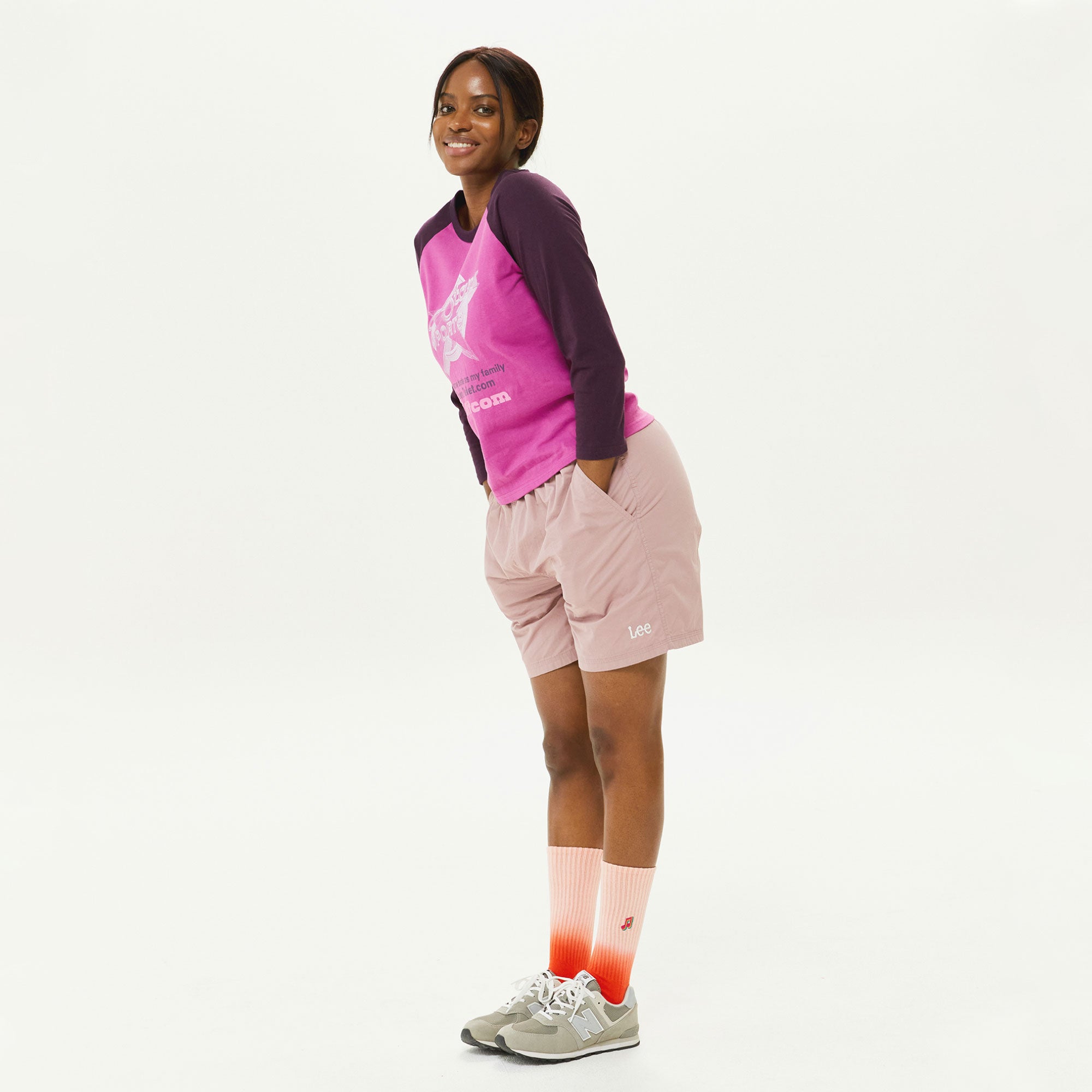 A woman in a pink shirt and pink shorts.