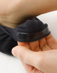 A person holding a black object in their hand.