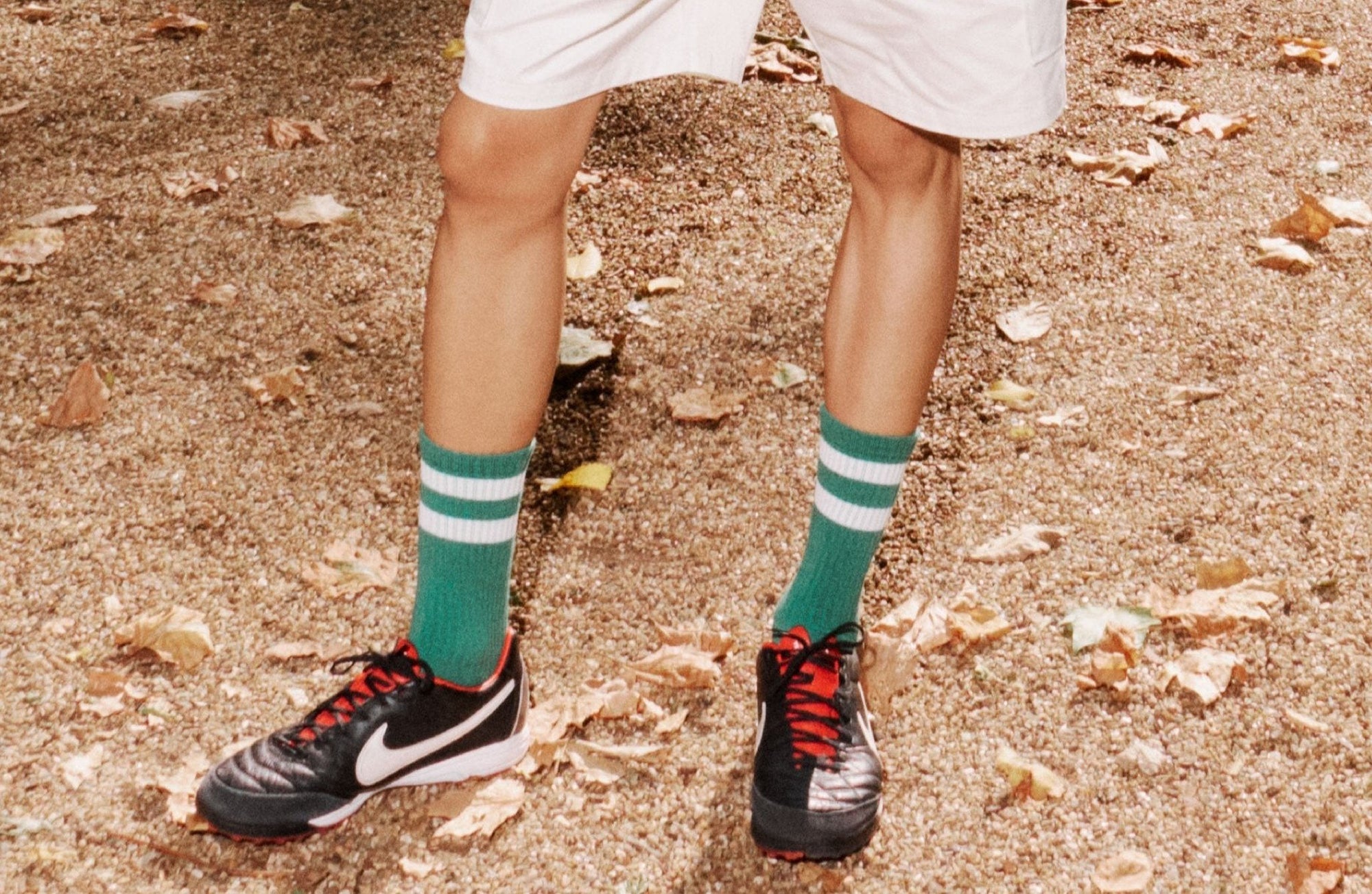 A man in shorts and socks holding a frisbee.