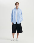 A man in a blue shirt and black shorts.