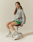 A woman sitting on a chair with her legs crossed.