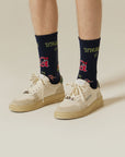 A man wearing a pair of white tennis shoes.