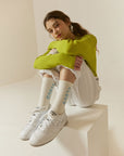 A woman sitting on top of a white box.