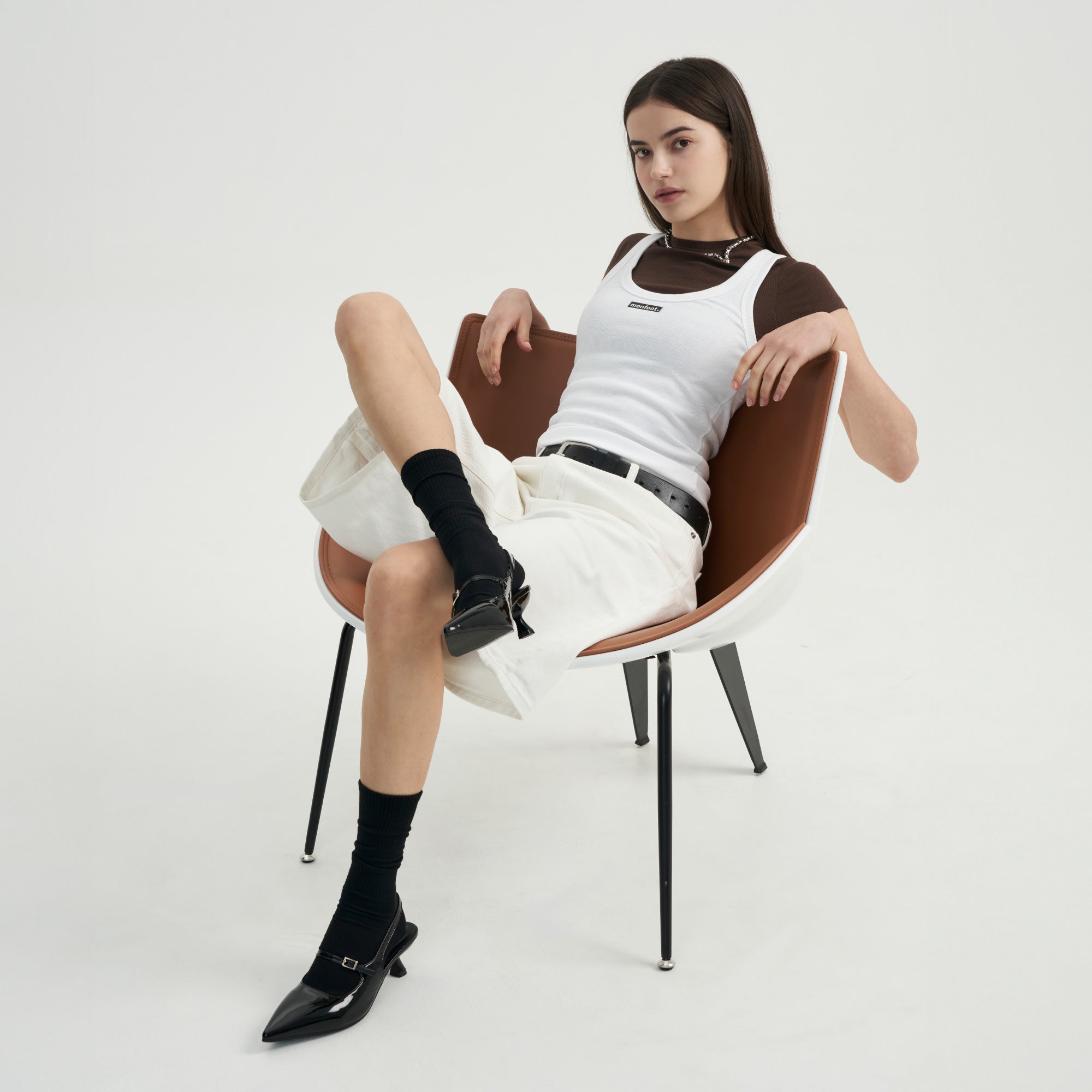 A woman sitting in a chair with her legs crossed.