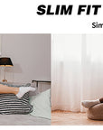 A woman laying on top of a bed next to a chair.