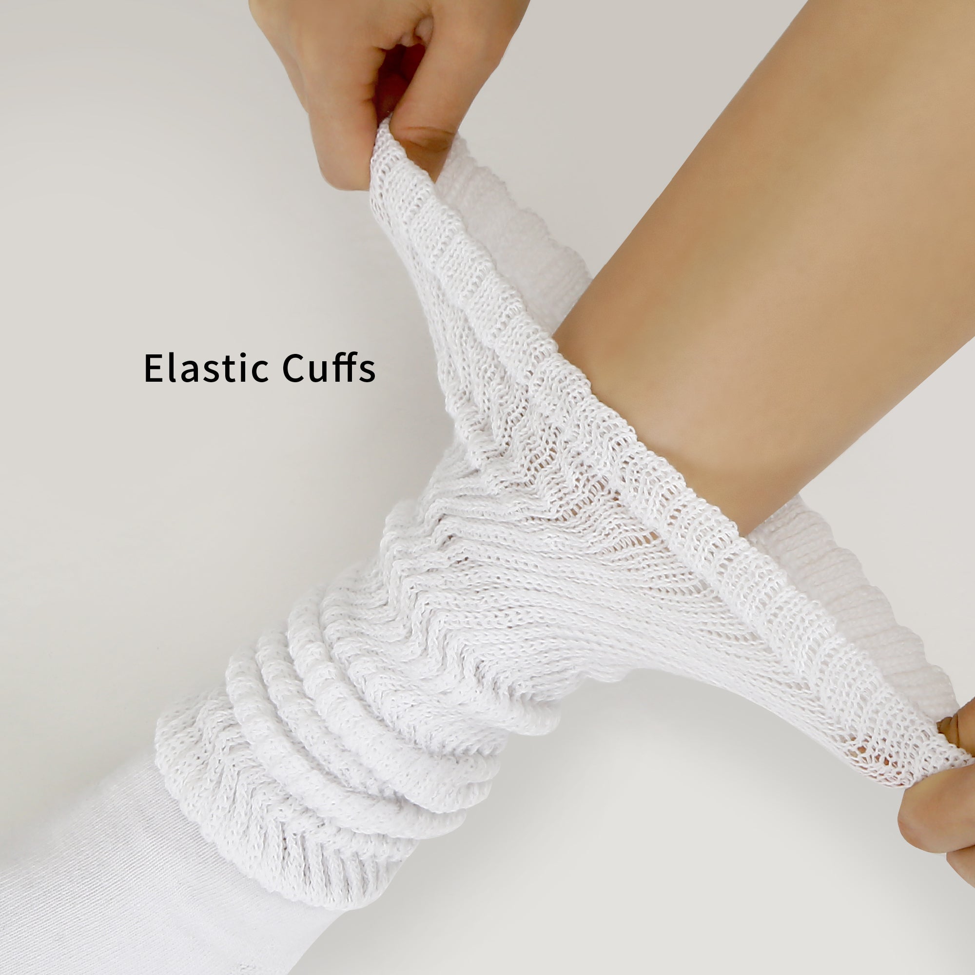 A pair of white socks with a woman's arm wrapped around them.
