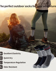 A woman sitting on top of a mountain next to a pair of socks.