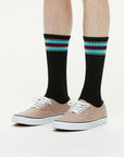 Model wearing Athletic Cushion Double Stripes Crew 3 Pairs Socks.