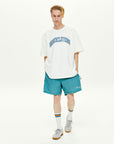 A man in a white t - shirt and blue shorts.