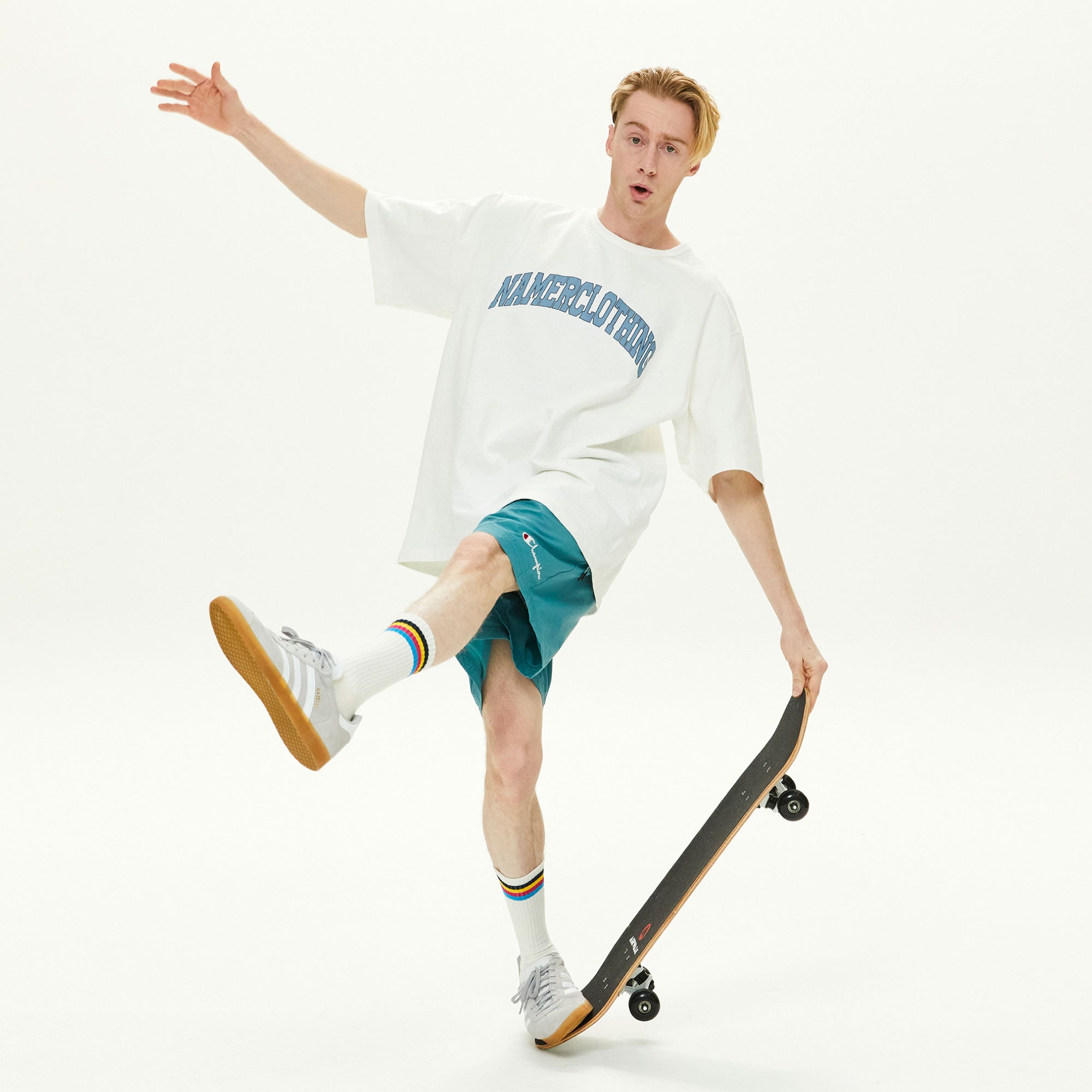 A young man riding a skateboard while holding a skateboard.