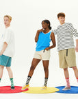 A group of three people standing on top of a rug.