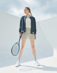 A woman holding a tennis racquet on a tennis court.