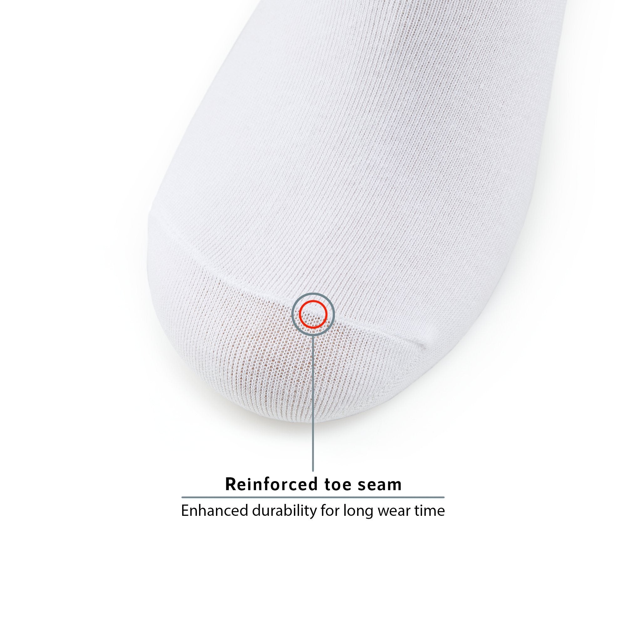 A white pillow with a red dot on it.