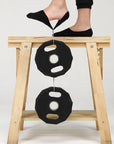 A woman standing on top of a wooden stool.
